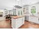 Open kitchen with a butcher block island, stainless steel appliances, and hardwood floors adjacent to living space at 14220 Stewarts Bend Ln, Charlotte, NC 28277