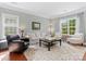 Bright living room featuring hardwood floors, large windows, and neutral décor at 14220 Stewarts Bend Ln, Charlotte, NC 28277