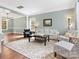 Open-concept living room with hardwood floors, large windows, and elegant décor at 14220 Stewarts Bend Ln, Charlotte, NC 28277