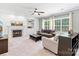 Inviting living room with fireplace, built-ins, and large windows providing natural light at 14220 Stewarts Bend Ln, Charlotte, NC 28277