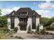 Charming two-story home features a well-manicured lawn, brick exterior, and dark-framed windows at 1437 Montford Dr, Charlotte, NC 28209