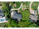 Aerial view of a well-maintained property featuring mature trees, manicured lawns, and a swimming pool at 17040 Jetton Rd, Cornelius, NC 28031