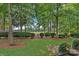 Beautiful backyard with lush green grass, mature trees, manicured hedges and golf course view at 17040 Jetton Rd, Cornelius, NC 28031