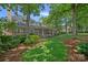 Expansive backyard featuring lush greenery, a covered patio, and well-manicured landscaping at 17040 Jetton Rd, Cornelius, NC 28031