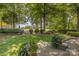 Scenic backyard view showcasing lush landscaping, mature trees, and distant views of the golf course at 17040 Jetton Rd, Cornelius, NC 28031