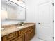 Bathroom featuring granite counters, wood cabinetry, and a well lit vanity at 17040 Jetton Rd, Cornelius, NC 28031