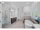 This luxurious bathroom features a modern soaking tub, glass-enclosed shower, and a spacious vanity at 17040 Jetton Rd, Cornelius, NC 28031