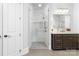 Bright bathroom featuring a modern glass shower, gray tile flooring, and a large vanity with great lighting at 17040 Jetton Rd, Cornelius, NC 28031