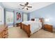 Cozy bedroom with blue walls, a ceiling fan, and a wood-framed bed at 17040 Jetton Rd, Cornelius, NC 28031
