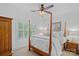 Bright bedroom with a four-poster bed, neutral bedding, and plantation shutters at 17040 Jetton Rd, Cornelius, NC 28031