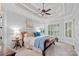Tranquil bedroom with a tray ceiling, plantation shutters, and warm, inviting decor at 17040 Jetton Rd, Cornelius, NC 28031