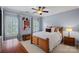 Comfortable bedroom with bed, neutral bedding, and natural light from shuttered windows at 17040 Jetton Rd, Cornelius, NC 28031