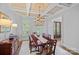 Elegant dining room features coffered ceilings, plantation shutters, chandelier, and ample natural light at 17040 Jetton Rd, Cornelius, NC 28031