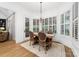 Elegant dining room with natural light and a wooden table set for four at 17040 Jetton Rd, Cornelius, NC 28031