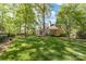 Beautiful brick home with a sprawling backyard and a covered patio, surrounded by mature trees at 17040 Jetton Rd, Cornelius, NC 28031