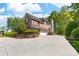 Elegant brick home with a three-car garage, mature landscaping, and a spacious driveway at 17040 Jetton Rd, Cornelius, NC 28031