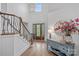 Bright foyer with soaring ceilings, hardwood floors, grand staircase and stylish decor offers a welcoming ambiance at 17040 Jetton Rd, Cornelius, NC 28031