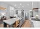 Bright kitchen features a spacious island with stainless steel appliances and farmhouse style sink at 17040 Jetton Rd, Cornelius, NC 28031