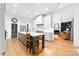 Stylish kitchen with large island, white cabinets, and hardwood floors at 17040 Jetton Rd, Cornelius, NC 28031