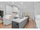 This expansive kitchen boasts an island, gas range, custom cabinetry, and open access to the dining area at 17040 Jetton Rd, Cornelius, NC 28031