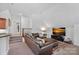Spacious living area with plush seating, a modern TV, and a cozy atmosphere at 17040 Jetton Rd, Cornelius, NC 28031