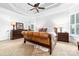 Spacious main bedroom featuring a tray ceiling, carpet, and lamps at 17040 Jetton Rd, Cornelius, NC 28031