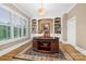 Office with custom built-ins, a large desk, and natural light from window with shutters at 17040 Jetton Rd, Cornelius, NC 28031
