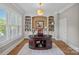 Sophisticated home office features custom built-ins, plantation shutters, a large desk, and neutral color palette at 17040 Jetton Rd, Cornelius, NC 28031