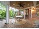Inviting covered patio with wood ceiling and an outdoor dining set situated on a circular rug at 17040 Jetton Rd, Cornelius, NC 28031