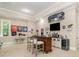 Entertainment area features a stylish bar with seating, a mounted TV, and unique decor at 1713 Mt Isle Harbor Dr, Charlotte, NC 28214
