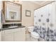 Bathroom with granite countertop, vanity, toilet and shower with modern patterned shower curtain at 1713 Mt Isle Harbor Dr, Charlotte, NC 28214