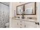 Stylish bathroom featuring double sinks, granite countertops, and a shower with curtain at 1713 Mt Isle Harbor Dr, Charlotte, NC 28214