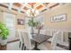 Elegant dining room features a coffered ceiling, stylish chandelier, and ample seating for formal gatherings at 1713 Mt Isle Harbor Dr, Charlotte, NC 28214