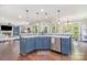 Kitchen island with blue cabinetry and stainless steel dishwasher and an open concept layout at 1713 Mt Isle Harbor Dr, Charlotte, NC 28214