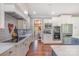 This modern kitchen has stainless appliances, custom cabinets, and a view into the dining room at 1713 Mt Isle Harbor Dr, Charlotte, NC 28214