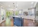 Bright, open kitchen with a large island, white cabinets, and a breakfast nook with natural light at 1713 Mt Isle Harbor Dr, Charlotte, NC 28214