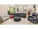 Inviting living room with a comfy black sectional, an ottoman, and plentiful natural light at 1713 Mt Isle Harbor Dr, Charlotte, NC 28214