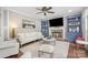 Cozy living room features a stone fireplace with built-in shelving, a plush sofa, and stylish decor for relaxation at 1713 Mt Isle Harbor Dr, Charlotte, NC 28214