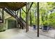 Covered patio area with outdoor seating, a storage shed, and staircase access to the yard at 1713 Mt Isle Harbor Dr, Charlotte, NC 28214
