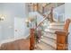 Elegant staircase with wood and iron detailing, complemented by hardwood flooring and stylish wall sconces at 1713 Mt Isle Harbor Dr, Charlotte, NC 28214