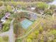 Aerial view of the community tennis courts, parking lot, and surrounding neighborhood at 1713 Mt Isle Harbor Dr, Charlotte, NC 28214