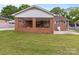 A covered porch overlooks the expansive, well-maintained backyard at 182 Ryan St, Salisbury, NC 28144