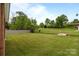 A large grassy backyard featuring mature trees, with partial fencing at 182 Ryan St, Salisbury, NC 28144