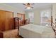 Bedroom with hardwood floors, ceiling fan, and two large windows with white curtains at 182 Ryan St, Salisbury, NC 28144