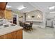 Eat-in kitchen with floral wallpaper, wood cabinets, and washer and dryer at 182 Ryan St, Salisbury, NC 28144