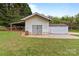 Exterior of a vintage white outbuilding on a well-maintained lawn, with concrete pad and ample storage space at 182 Ryan St, Salisbury, NC 28144
