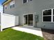 Backyard with green grass, a white fence, and a sliding door to the home at 2021 Endeavor Run, Charlotte, NC 28269