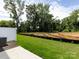 Backyard with green grass, white fence, AC Unit, and trees in the background at 2021 Endeavor Run, Charlotte, NC 28269
