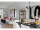 Open-concept dining area with decorative elements, adjoining a living room with a comfortable sofa at 2021 Endeavor Run, Charlotte, NC 28269