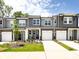 Charming new townhomes with attached garages and modern gray siding at 2021 Endeavor Run, Charlotte, NC 28269